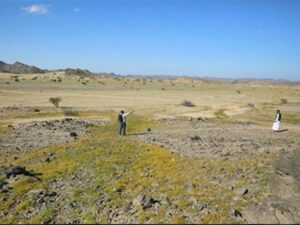 Ababda guide and tourist in the green landscape of the Eastern Desert