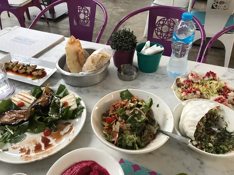 A table displaying Haloumi Cheese and Fattouch Salad and Meatballs with Roman and Tahina with Beetroot