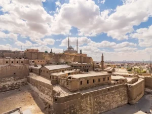 White clouds on a blue sky and a view of the Citadel complex in Cairo