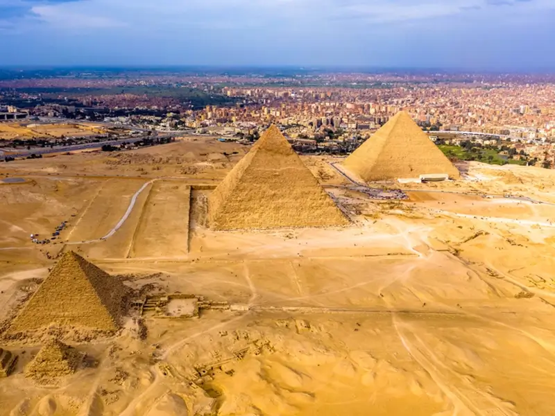 The pyramids of Giza from above with a view of Cairo