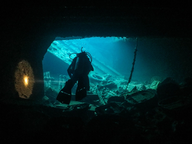 Scuba diver inside the Thistlegorm shipwreck in the Red Sea